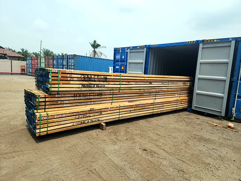 Dowlet sawn timber bundles marked Produce of Malaysia, ready to load into a shipping container