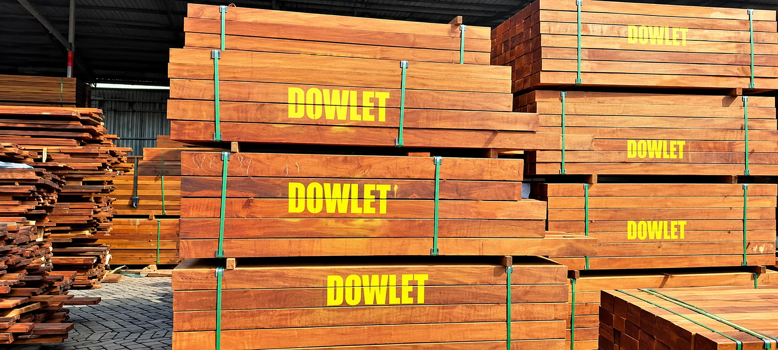 DOWLET-branded bundles of sawn timber stacked in a covered timber yard