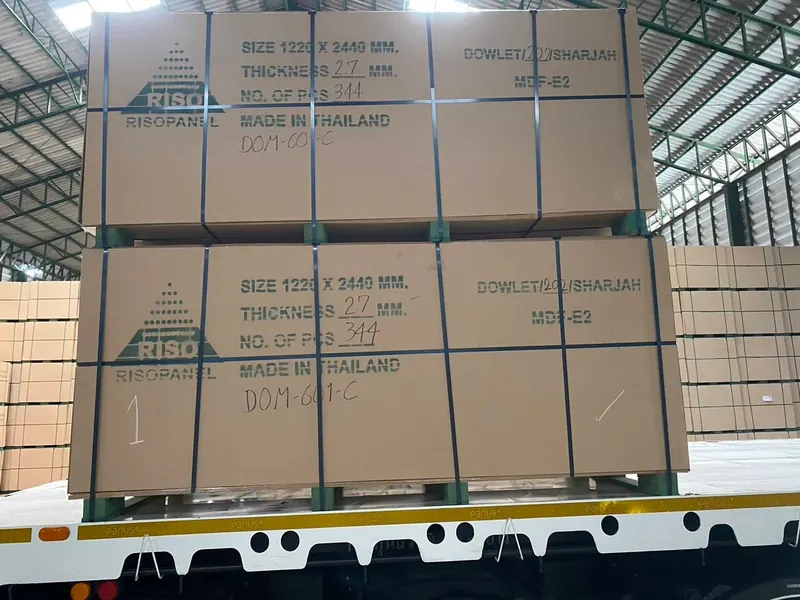Packed MDF bundles labelled 1220 × 2440 mm for a Dowlet consignment
